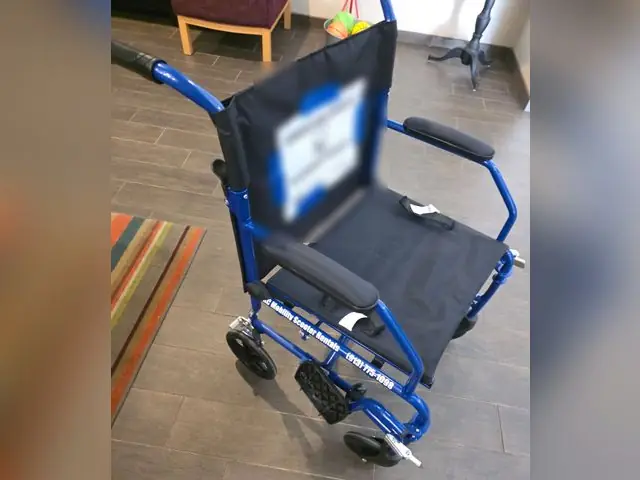 Blue lightweight transport chair from KC Mobility Scooter Rentals, set up and ready for a customer