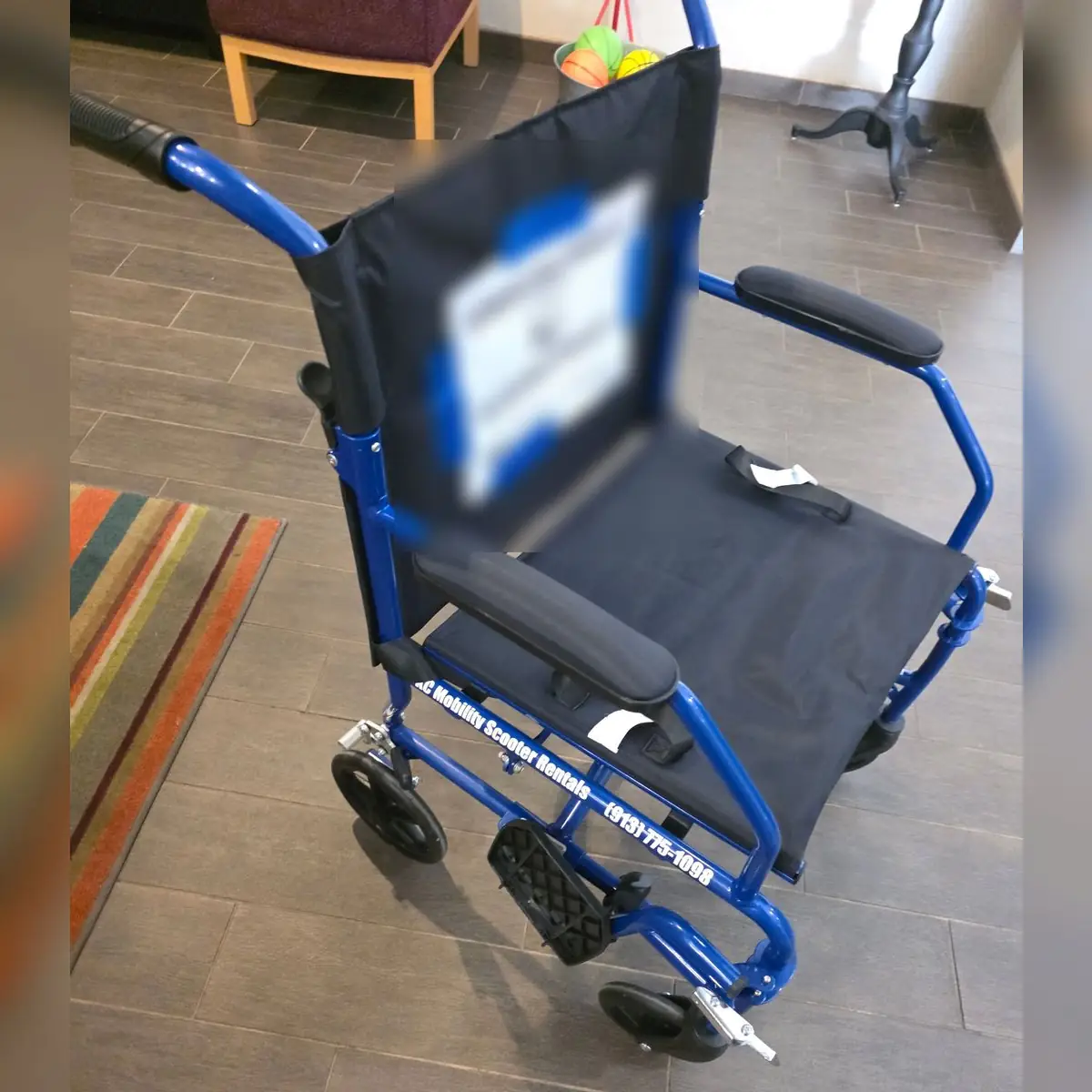 Blue lightweight transport chair from KC Mobility Scooter Rentals, set up and ready for a customer