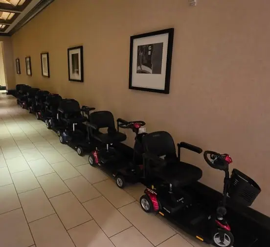 Mobility scooters from KC Mobility Scooter Rentals lined up in a Kansas City hotel conference corridor, staged and ready for a corporate event.
