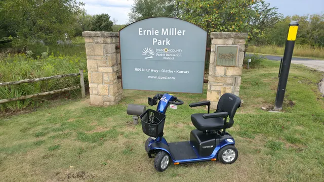 Mobility scooter at the Ernie Miller Park sign, Olathe